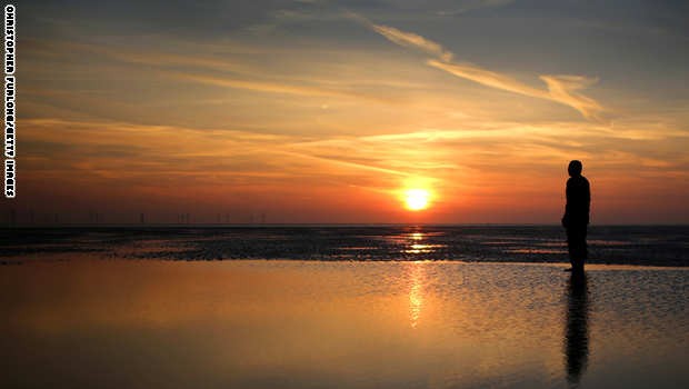 Antony Gormley's 'Another Place' At Sunset In Crosby